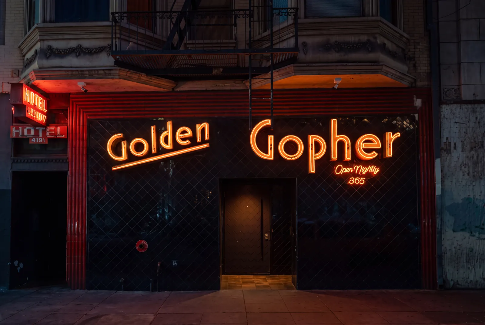 The Golden Gopher storefront on 8th Street, neon lit at dusk